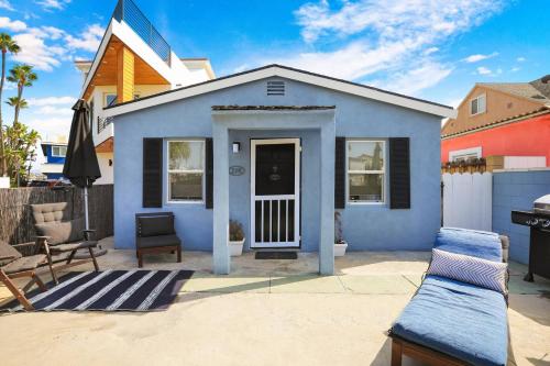 a blue house with a porch and a patio at 210 Forty Fourth Street in Newport Beach