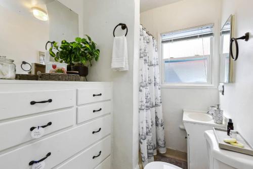 a bathroom with a white dresser and a sink at 210 Forty Fourth Street in Newport Beach