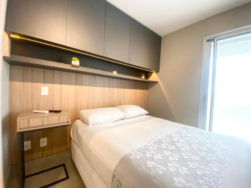 a small bedroom with a bed and a window at Flat WiseSP - Expo Anhembi in Sao Paulo