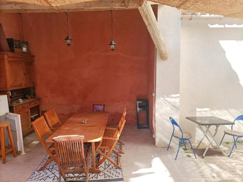 a dining room with a wooden table and chairs at T2 Duplex "Chez Évelyne" in Remoulins