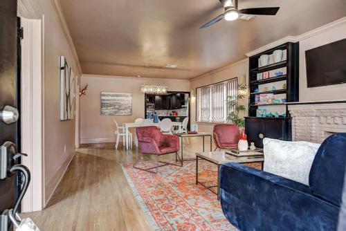 a living room with a blue couch and a table at Boho Glam Bungalow mins away Western Ave Districts in Oklahoma City