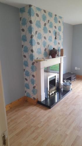 a living room with a fireplace in a room at Hawthorn Walk in Kilkenny