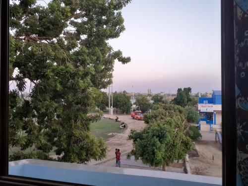 a view of a park from a window at Nile Roof Hotel& Restaurant in Luxor