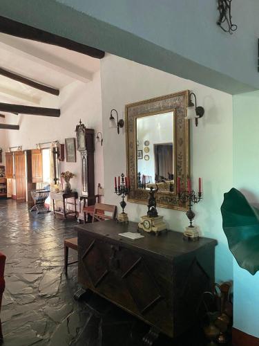a living room with a mirror and a table at Quinta Castanheiro da Penha - Alegrete - Portalegre - Alentejo in Alegrete