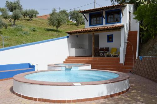 a small pool in front of a house at Casas De Romaria in Brotas