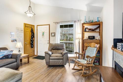 a living room with a couch and a chair at Cedar Creek Retreat in Rockaway Beach
