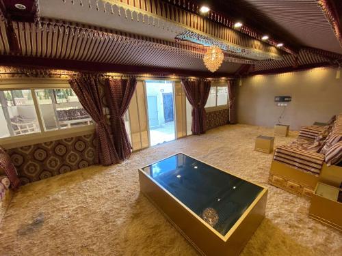 a large living room with a large tub in the middle at منتجع ليالي الحنين Layali Alhanin Resort in Al Hada