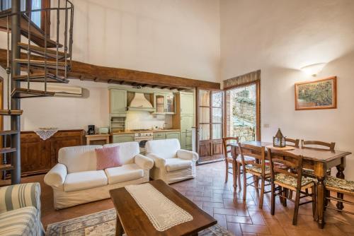 a living room with a couch and a table at Agriturismo La Ferrozzola in Castellina in Chianti