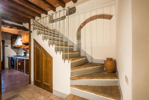a stairway in a kitchen with a stair case at Agriturismo La Ferrozzola in Castellina in Chianti