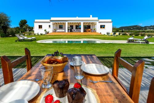 a wooden table with food on top of a house at Villa Can Jaume Arabí de Baix in Puig D’en Valls