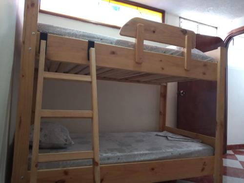 a bunk bed in a tiny house at Estadio APARTE HOTEL 203 in Medellín