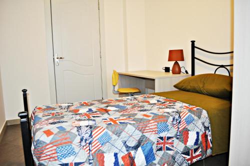 a bedroom with a bed with a quilt on it at Residence Le Groane in Garbagnate Milanese