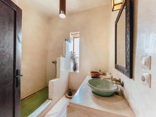 a bathroom with a large bowl sink on a counter at LE BLED DE GRE in Marrakech