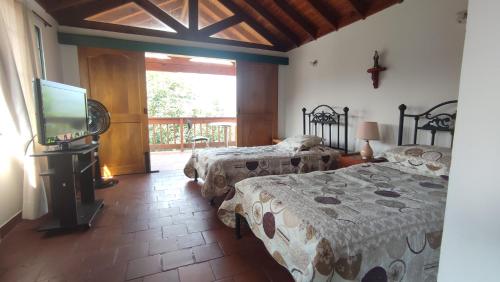 Ліжко або ліжка в номері New Paradise Casa Campestre