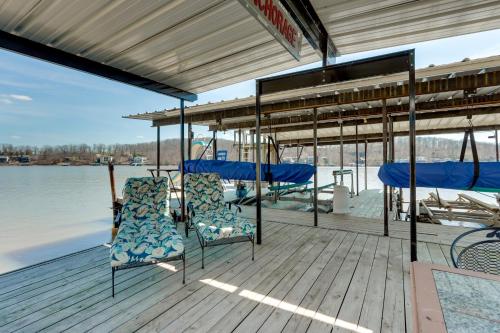 a boat deck with chairs on the water at Waterfront Lake of the Ozarks Home with Private Dock in Roach