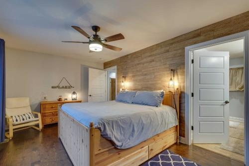 a bedroom with a bed and a ceiling fan at Lakefront Butler Home with Hot Tub, Fire Pit and Dock in Butler