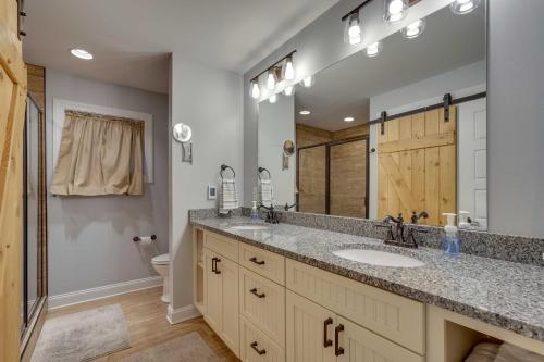 a bathroom with a sink and a large mirror at Lakefront Butler Home with Hot Tub, Fire Pit and Dock in Butler