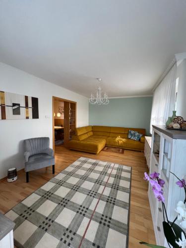 a living room with a couch and a rug at Apartament Acasa in Spielberg