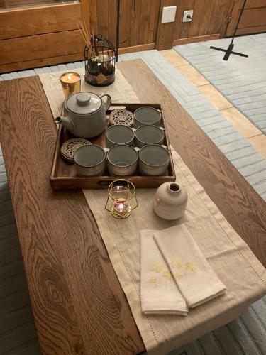 a table with a tray with pots and pans on it at Grand studio à Ovronnaz in Ovronnaz