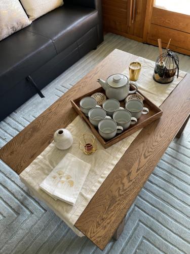 a coffee table with a tea set on top of it at Grand studio à Ovronnaz in Ovronnaz