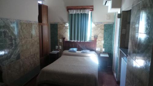 a small bedroom with a bed and a window at Hotel Virreyes in San Fernando