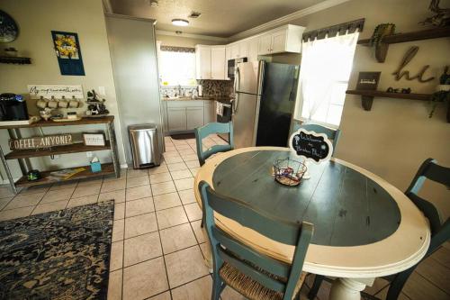a kitchen with a table and chairs and a refrigerator at Bristow Blue - Lake front with Boat Ramp Access!! in Canadian