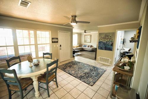a dining room and living room with a table and chairs at Bristow Blue - Lake front with Boat Ramp Access!! in Canadian