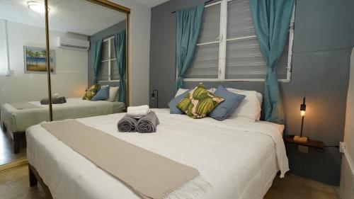 a bedroom with two large beds and a mirror at The Pelican Poshtel in San Juan