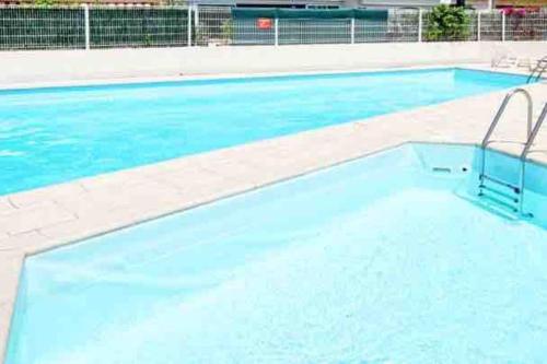 a large swimming pool with blue water at Superbe appartement avec piscine l'été in Nice