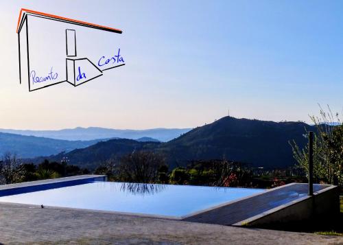 a swimming pool with a view of the mountains at Recanto da Costa in Riba de Mouro
