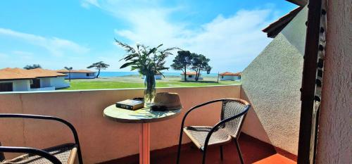 a balcony with a table and chairs and a view of the ocean at FKK Ada Bojana in Ulcinj