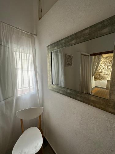a bathroom with a white toilet and a mirror at Apartamento en el casco histórico in Tarifa