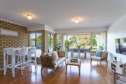 a living room with a couch and a table at Cotton Tree Beach in Maroochydore
