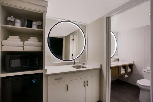 uma casa de banho com um lavatório e um espelho em Best Western Premier the Central Hotel & Conference Center em Harrisburg
