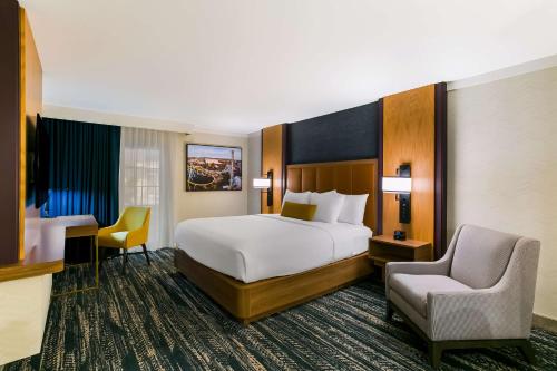 a bedroom with a bed and a desk and a chair at Best Western Premier the Central Hotel & Conference Center in Harrisburg