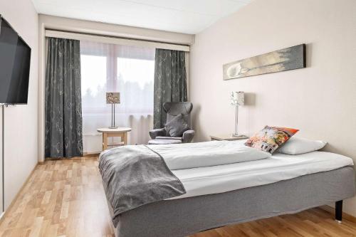 a bedroom with a bed and a chair and a window at Best Western Leto Arena in Dal