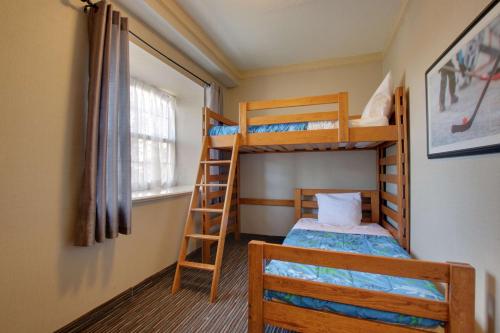 a bedroom with two bunk beds and a ladder at Best Western Brantford Hotel and Conference Centre in Brantford