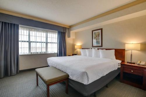 a hotel room with a large bed and a window at Best Western Brantford Hotel and Conference Centre in Brantford