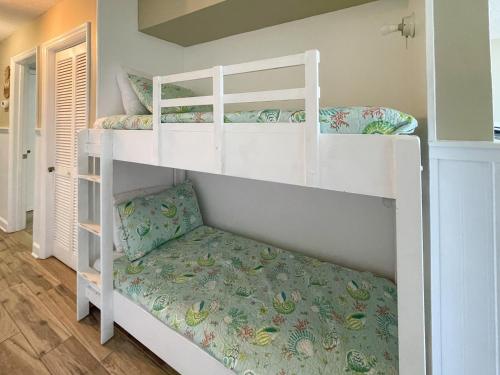 a couple of bunk beds in a room at 0412 Memories Made At The Beach by Atlantic Towers in Carolina Beach