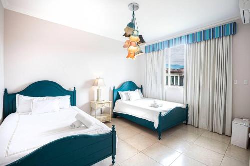 a bedroom with two beds and a window at Laguna Lake House - Private Pool - King Bed - Sleeps 14 in Playa Blanca