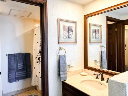 a bathroom with a sink and a mirror at Sandy Beach Princesa A103 Ocean Front Resort in Puerto Peñasco