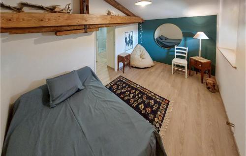 a bedroom with a bed and a desk and a mirror at Les Lumas in Taizé-Aizie