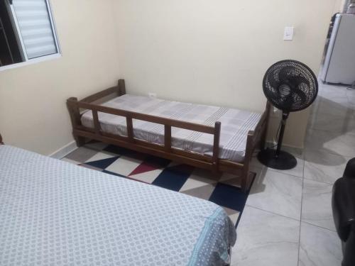 - une chambre avec des lits superposés et un ventilateur dans l'établissement Casa de praia verde mar, à Itanhaém