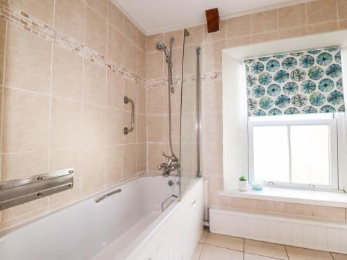a bathroom with a tub and a window at Park View in Bodmin