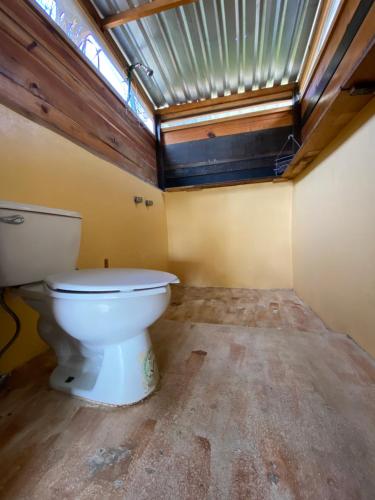 a bathroom with a toilet in a room at Chaak in Puerto Escondido