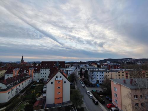 a view of a city with buildings and a cloudy sky at Wagners Panorama in Bayreuth