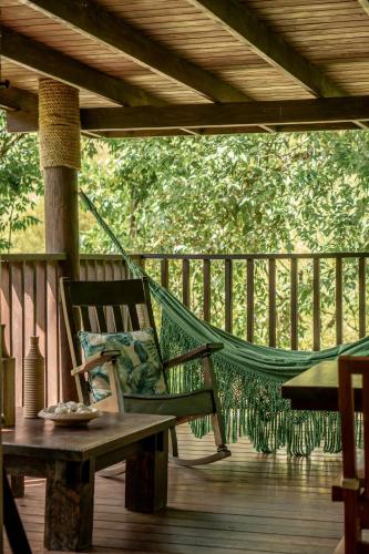 a hammock on the deck of a porch at Platon Ecolodge in Santa Cruz de Barahona