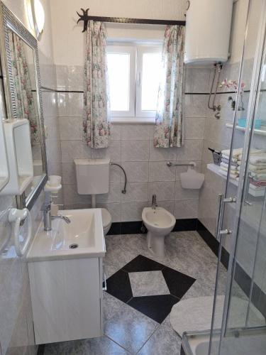 a bathroom with a sink and a toilet at Apartments by the sea Postira, Brac - 706 in Postira