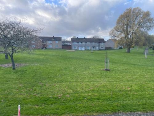a large grass field with houses in the background at Family room, Shared House in Bristol