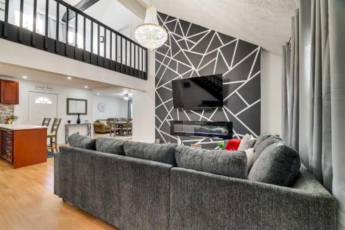 a living room with a couch and a tv at Furnished Deck and Fire Pit Home in Tobyhanna in Tobyhanna